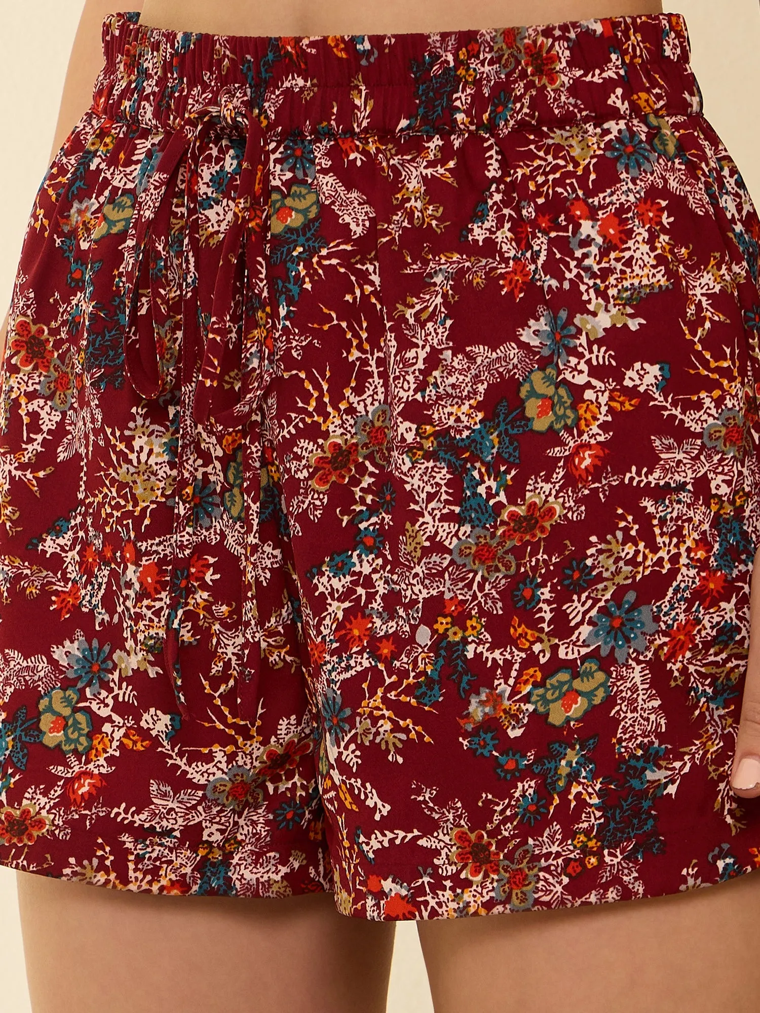 Berrylush Women Maroon Floral Printed High-Rise Elastic Waist Tie-Up Side-Slit Mini Summer Hot Pants